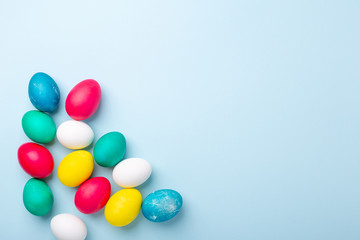Various colors easter eggs on blue background. Easter concept. Copy space for text