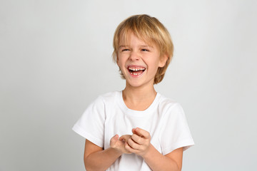 Happy little boy on light grey background