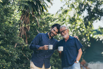 Old father and son, Morning coffee in a garden