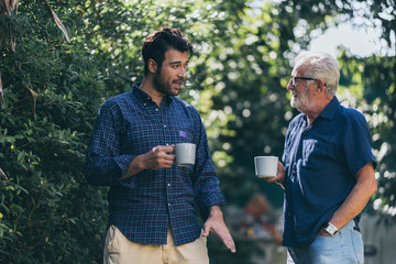 Old father and son, Morning coffee in a garden