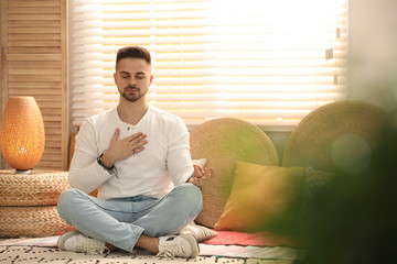 Young man during self-healing session in therapy room
