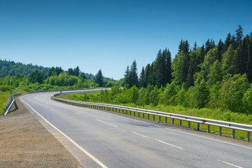 empty asphalt road with sharp turn