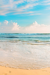 Fototapeta na wymiar Tropical sea shore. Cloudy sky and blue wavy ocean water. Sri Lanka.