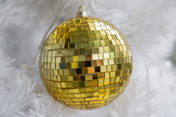 Golden Ball on White Christmas Tree