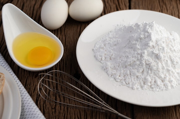 Eggs, tapioca flour and an egg beater, ingredients used in bakery