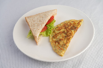 Omelette and sandwiches are in a color palette on a white background.