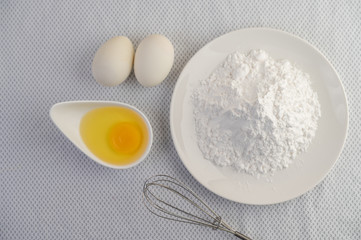 Eggs, tapioca flour and an egg beater, ingredients used in bakery