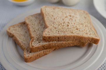A slice of bread on a plate on a white background