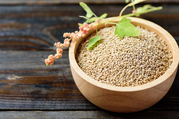 Organic raw brown quinoa seed in wooden bowl, healthy food