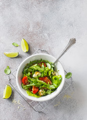 Fresh vegetable salad with lettuce, tomatoes, cucumbers and mozzarella