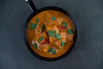 Massaman curry in a frying pan on the cement floo.