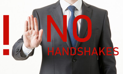 Unrecognizable businessman reminds to avoid handshakes