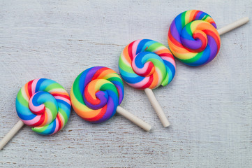Lollipops on white wooden background. colorful candies close up