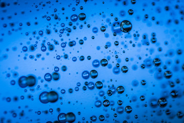 Fototapeta na wymiar Water droplets on blue