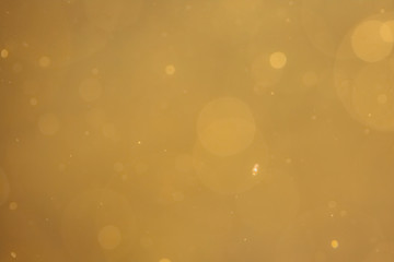 Dark Abstract Gold bokeh sparkle on black background