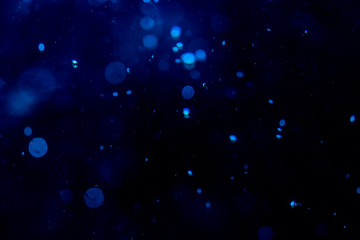 Fototapeta na wymiar Blur blue bokeh of light on black