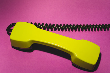 Vintage telephone handset. phone receiver on red background. old communication technology. copy...