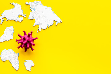 Corona virus Covid-19 - epidemic concept with world map - on yellow background top-down copy space