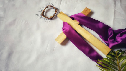 Lent Season,Holy Week and Good Friday concepts - image of wooden cross with purple cloth on it 