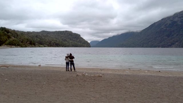 Romantic unknown couple staring at Correntoso lake , Villa la Angostura, Patagonia Argentina