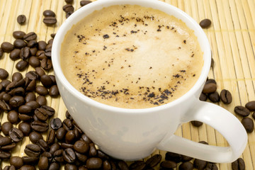 cup of coffee with coffee beans
