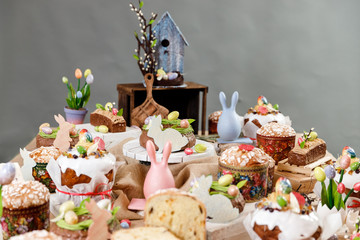 Easter cake orthodox sweet bread kulich and colorful chocolate eggs on festive table