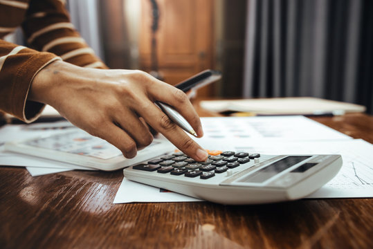 Female Accountant Or Banker Making Calculation Of Finance And Economy Banking Concept.