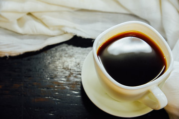 Espresso in a glass and White cloth on black wooden table,Top view