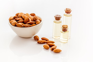Healthy nutrition. Almond oil in small bottles on white background