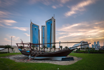 Traditional wooden dhow and high rise building in Bahrain, 