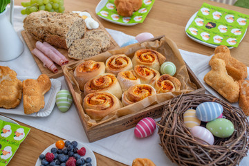 Easter holiday table. Easter cakes and colored eggs on a wooden table