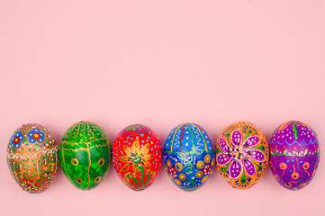 Beautiful hand-painted Easter eggs on a light pink background