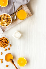 Homemade granola for morning meal. White desk with taost and fruits top-down frame copy space