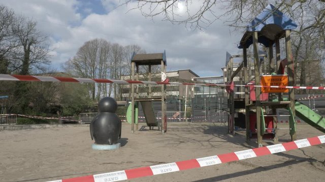 Playground with barrier tape, sign with prohibited access by police