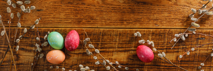Still life of easter eggs in a bird's nest on a wooden background. Rustic. Easter celebration concept. Copy space. Flat lay. Banner.
