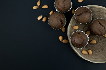 Top view simple chia seed almond chocolate muffins on a black background 