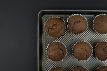 Top view simple chia seed chocolate muffins on a rustic baking sheet.