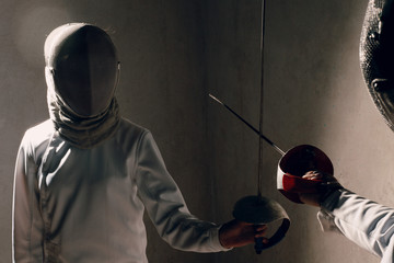 Martial arts. Fencer with fencing sword. Fencers duel concept.