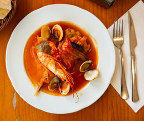 Monkfish tail in spicy sauce with shrimp and mussels