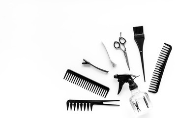 Professional hairdressing set with combs, spray and sciccors on white background top-down copy space