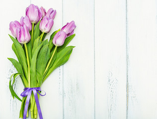 Bouquet of pink tulips on a white wooden background. Mother's and Valentine's Day, March Day.