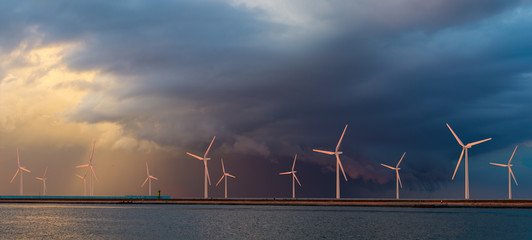 Offshore wind farm at beautiful, dramatic sunset
