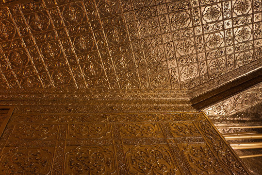 The gold plated ornate interior decoration near the Buddha relics in the Botahtaung Pagoda, Yangon, Myanmar