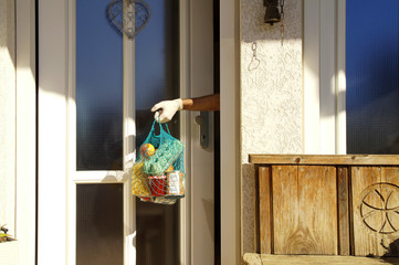 home delivering some groceries at quarantine time because of coronavirus infection COVID-19. man's...