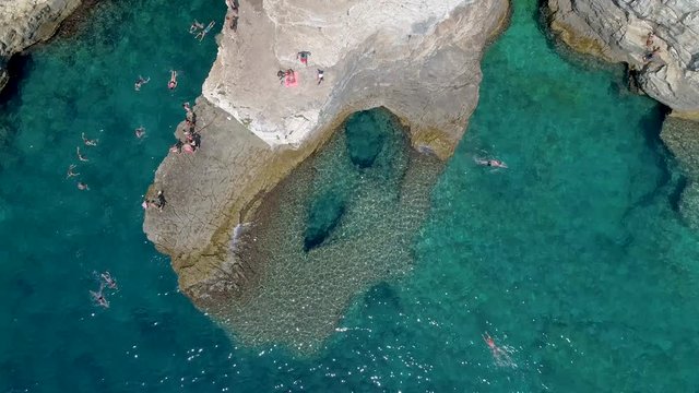 Grotto of Pula town, clean blue water of Adriatic sea with rocky beach, Istria region