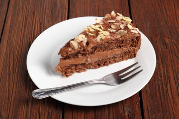Fototapeta na wymiar Chocolate sandwich cake garnished with flaked almonds