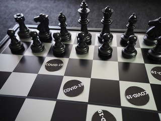 Chess pieces battling against  COVID-19 