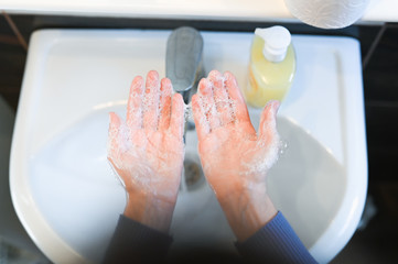 Coronavirus pandemic prevention wash hands with soap warm water and , rubbing nails and fingers washing frequently. Hygiene concept.