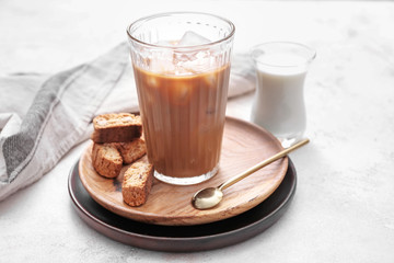 Glass of tasty iced coffee on table