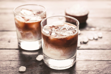 Glasses of tasty iced coffee on table